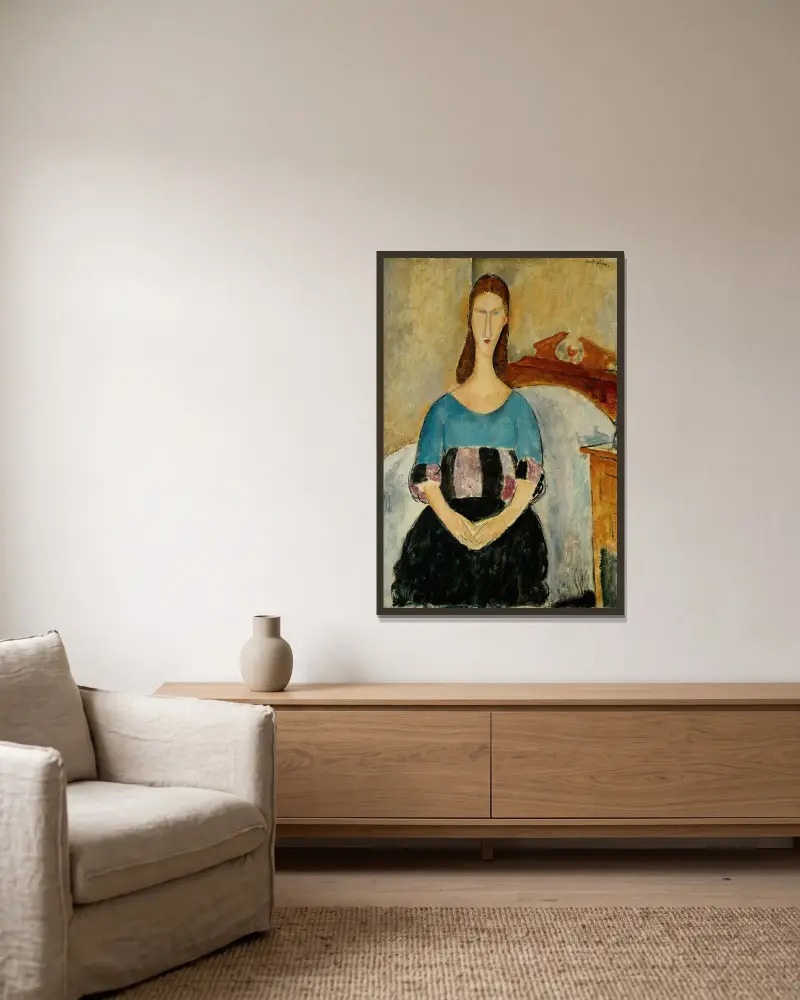 Porträtt av Jeanne Hébuterne, sittande av Amedeo Modigliani inramad på en vägg
