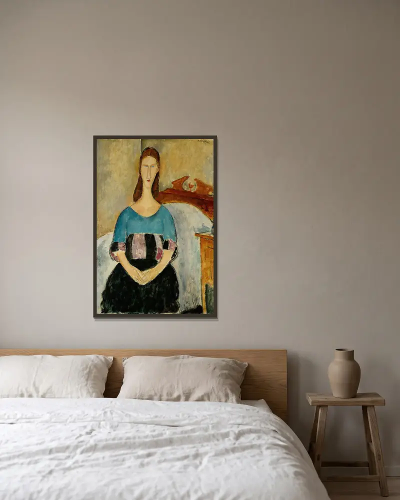 Porträtt av Jeanne Hébuterne, sittande av Amedeo Modigliani inramad på en vägg