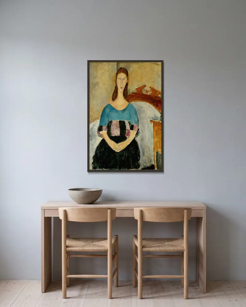 Porträtt av Jeanne Hébuterne, sittande av Amedeo Modigliani inramad på en vägg