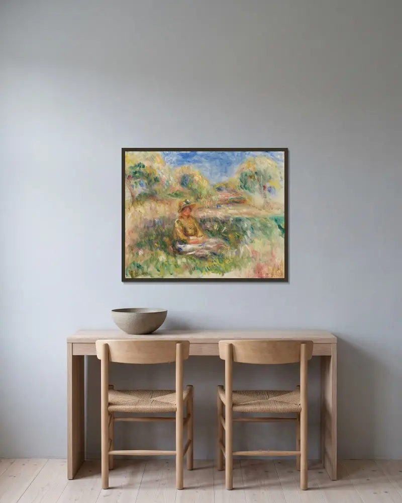 Femme assise dans un paysage av Pierre-Auguste Renoir inramad på en vägg