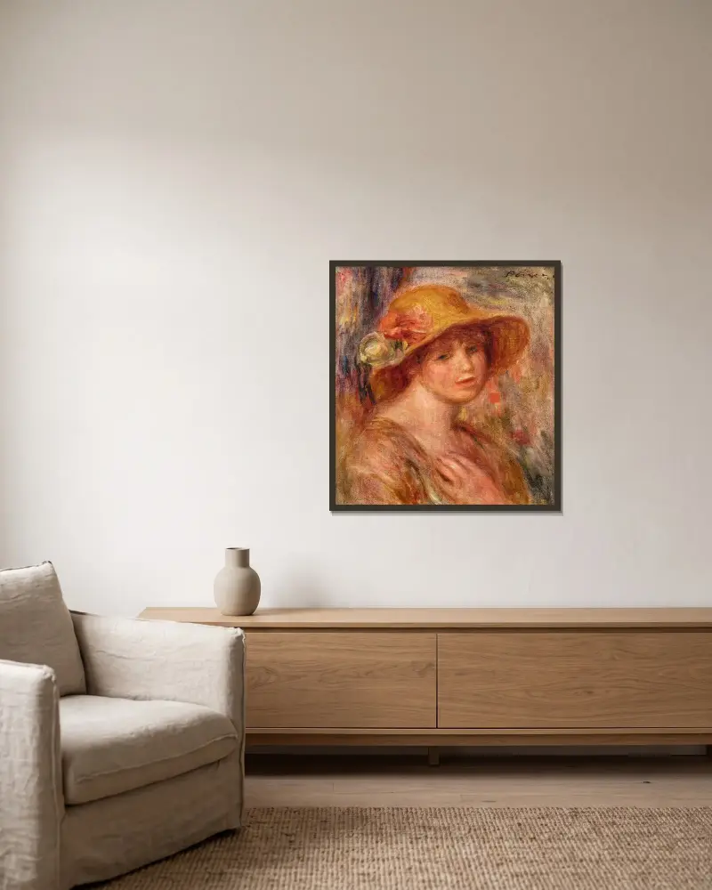 Kvinna med stråhatt av Pierre-Auguste Renoir inramad på en vägg