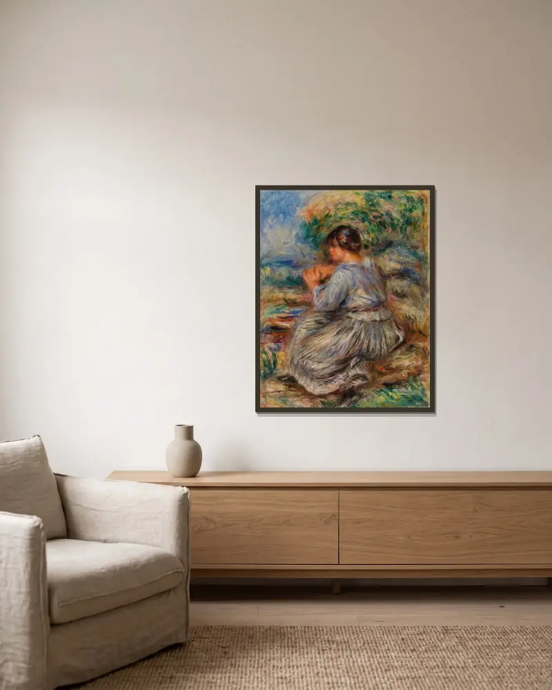 Flicka sittande i landskap av Pierre-Auguste Renoir inramad på en vägg