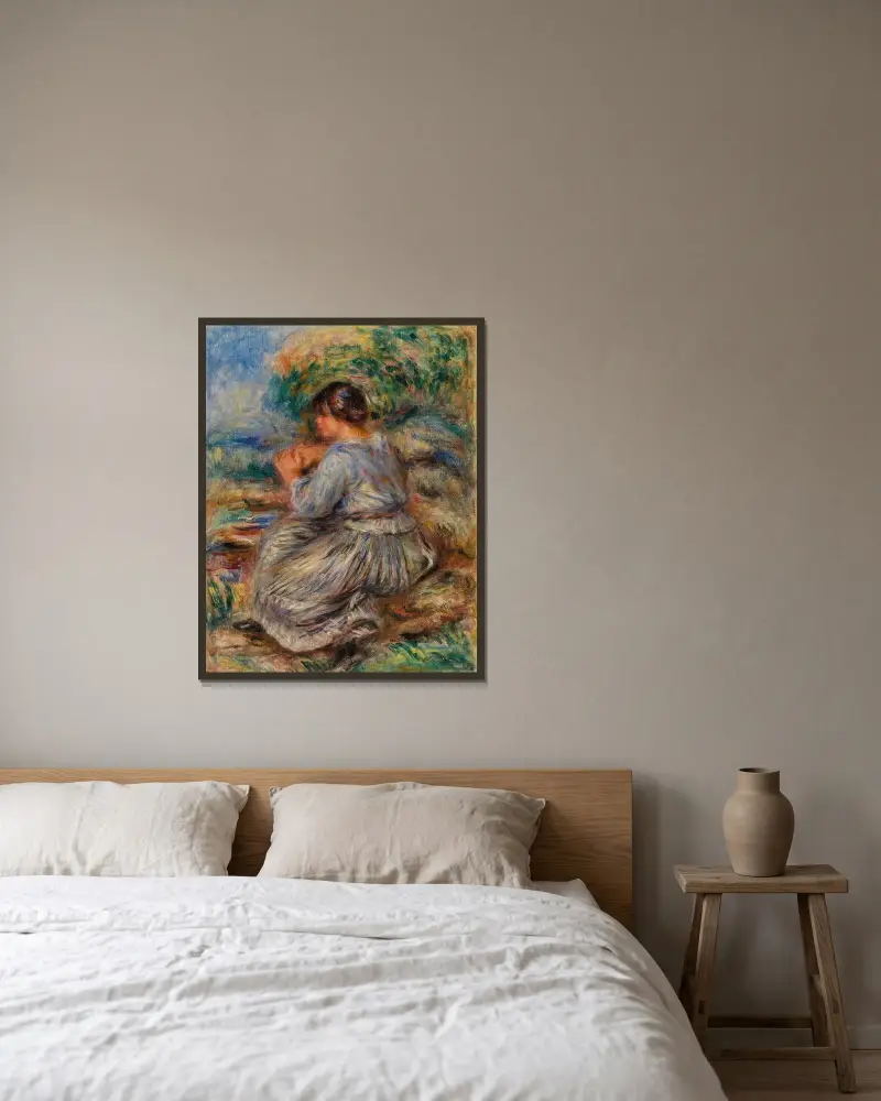 Flicka sittande i landskap av Pierre-Auguste Renoir inramad på en vägg