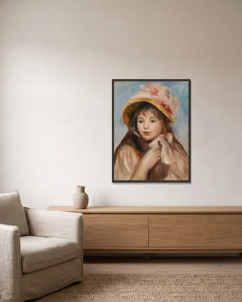 Mädchen mit rosa Haube von Pierre-Auguste Renoir gerahmt an einer Wand