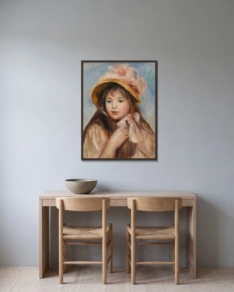 Mädchen mit rosa Haube von Pierre-Auguste Renoir gerahmt an einer Wand