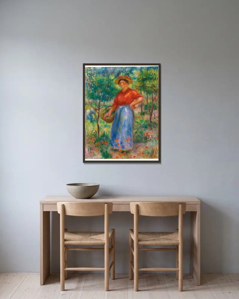 Ung flicka med korg (Gabrielle i trädgården) av Pierre-Auguste Renoir inramad på en vägg