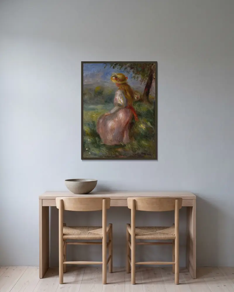 Flicka i rosa av Pierre-Auguste Renoir inramad på en vägg