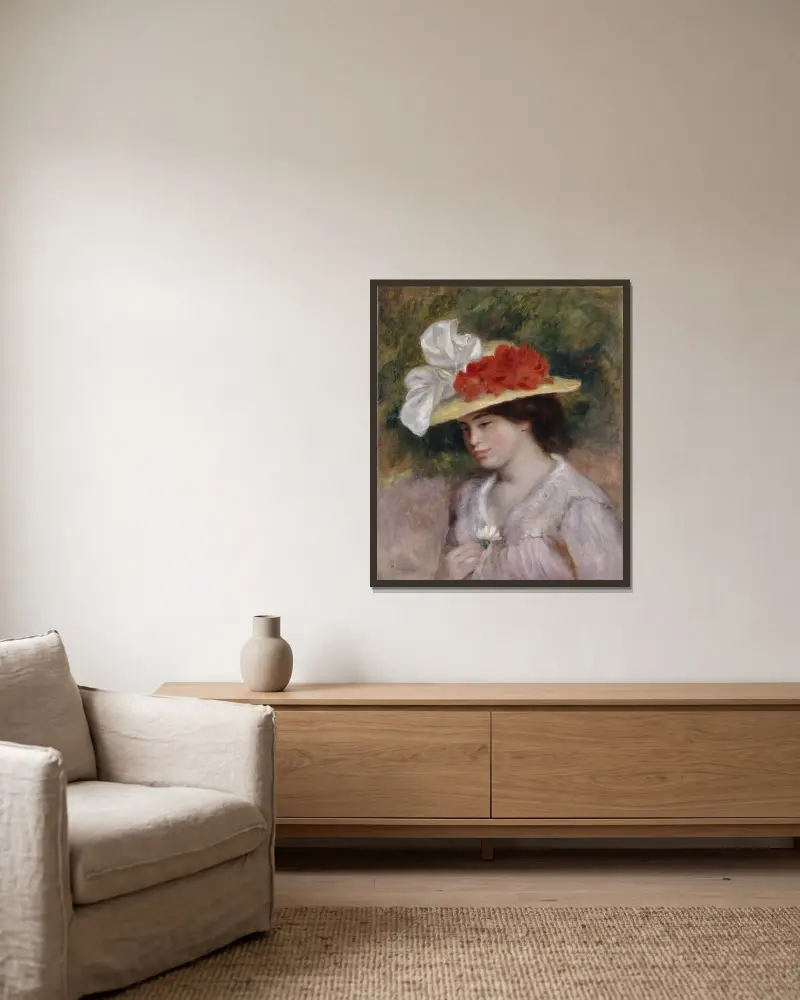 Frau mit Blumenhut von Pierre-Auguste Renoir gerahmt an einer Wand