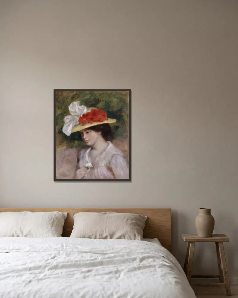 Frau mit Blumenhut von Pierre-Auguste Renoir gerahmt an einer Wand
