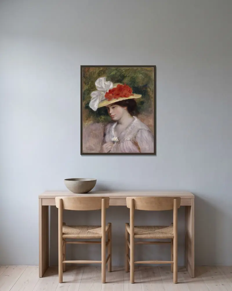 Frau mit Blumenhut von Pierre-Auguste Renoir gerahmt an einer Wand