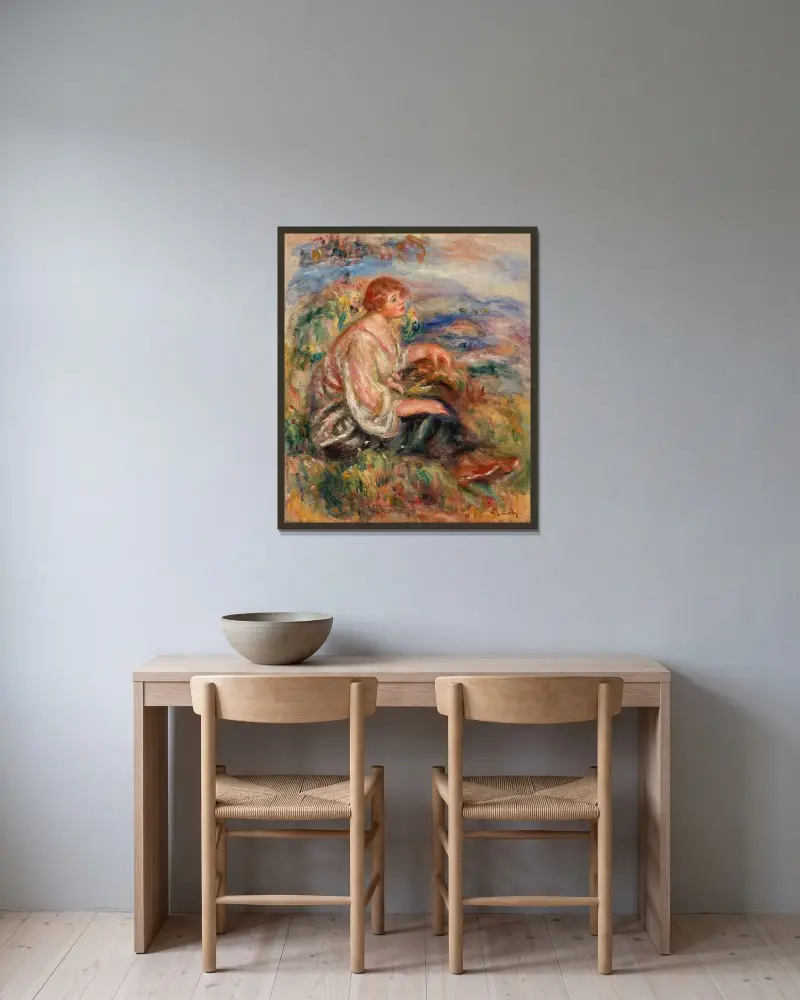 Frau in Tüllbluse und schwarzem Rock in einer Landschaft von Pierre-Auguste Renoir gerahmt an einer Wand