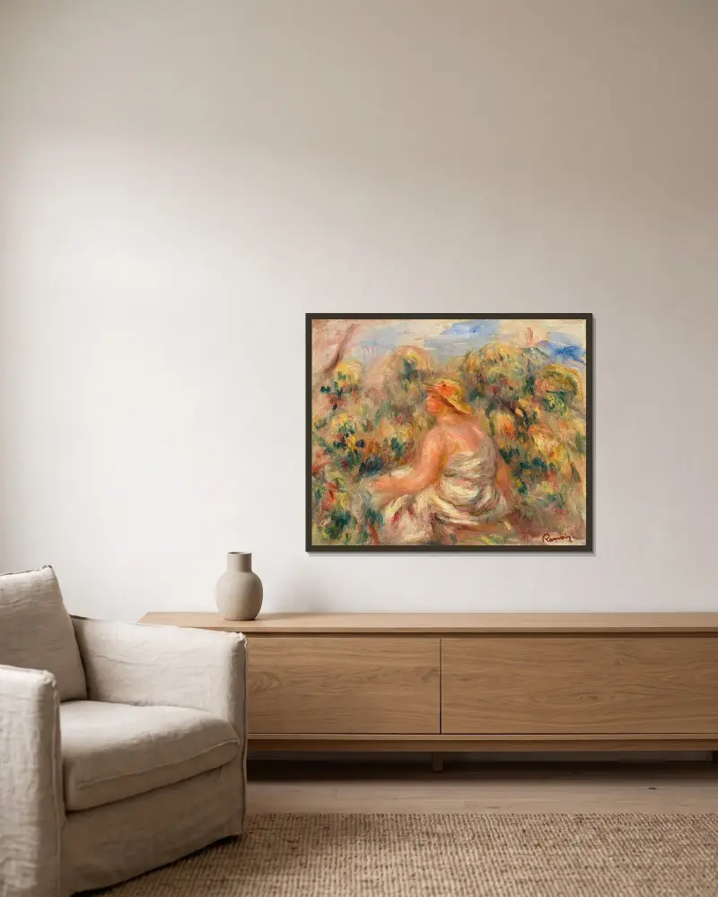 Frau mit Hut in einer Landschaft von Pierre-Auguste Renoir gerahmt an einer Wand