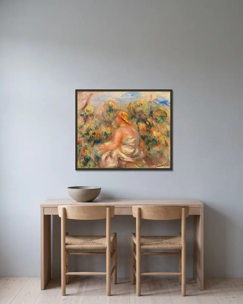 Frau mit Hut in einer Landschaft von Pierre-Auguste Renoir gerahmt an einer Wand