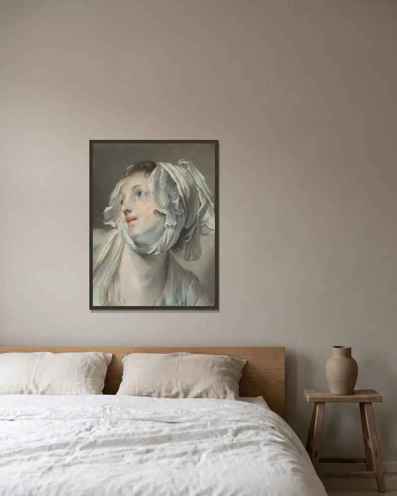 Huvud av en ung kvinna med mössa, vänd åt vänster av Jean-Baptiste Greuze inramad på en vägg
