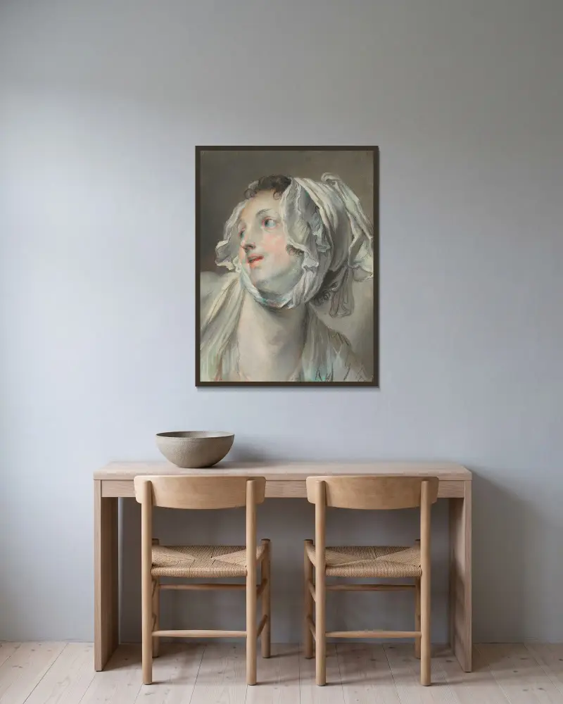 Huvud av en ung kvinna med mössa, vänd åt vänster av Jean-Baptiste Greuze inramad på en vägg