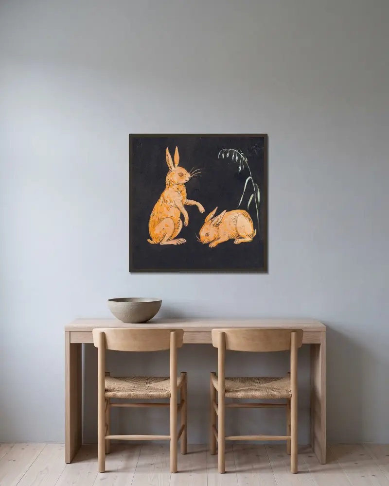 Två harar (kaniner) på svart bakgrund. Dekorativt utkast av P. C. Skovgaard inramad på en vägg