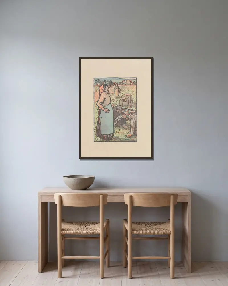 Les sarcleuses av Camille Pissarro inramad på en vägg