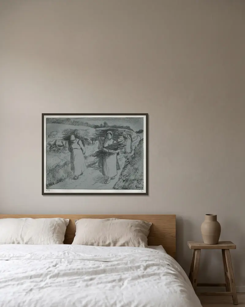 Bönder med risknippen av Camille Pissarro inramad på en vägg