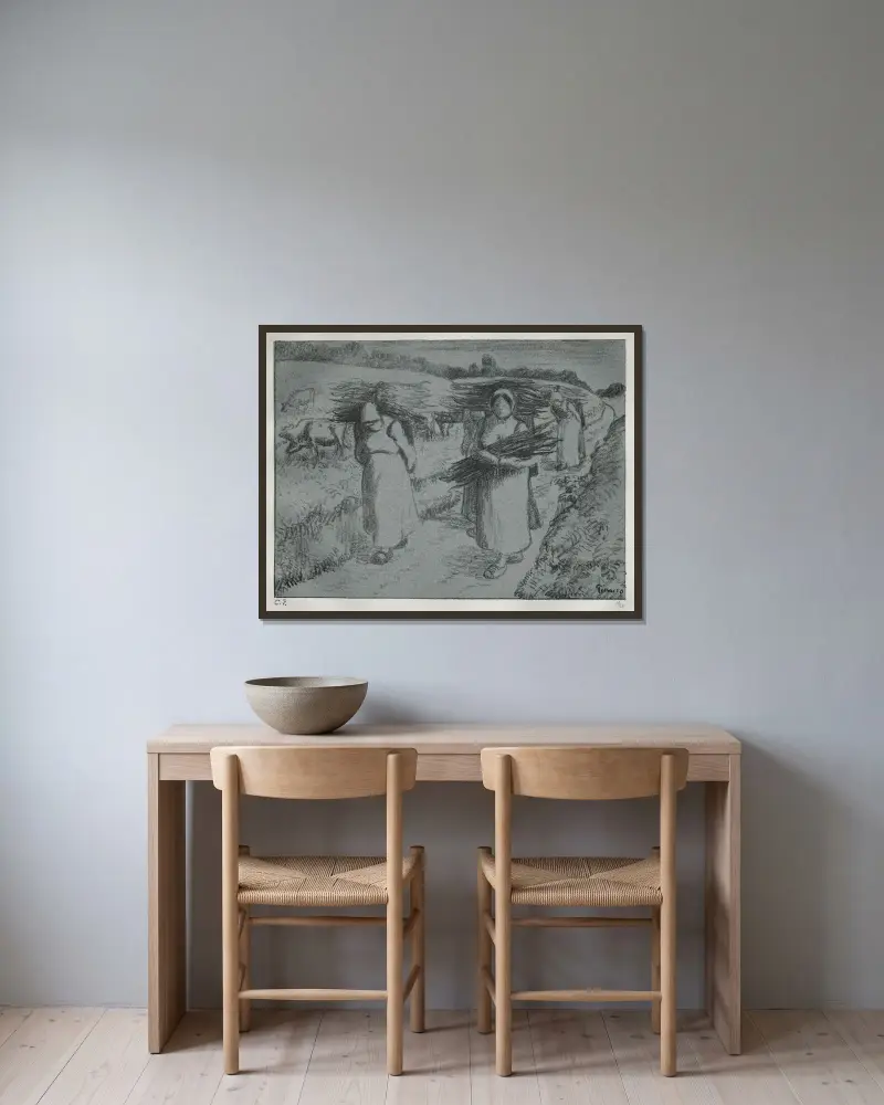 Bönder med risknippen av Camille Pissarro inramad på en vägg