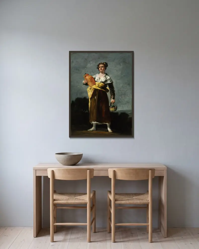 Die Wasserträgerin von Francisco de Goya gerahmt an einer Wand
