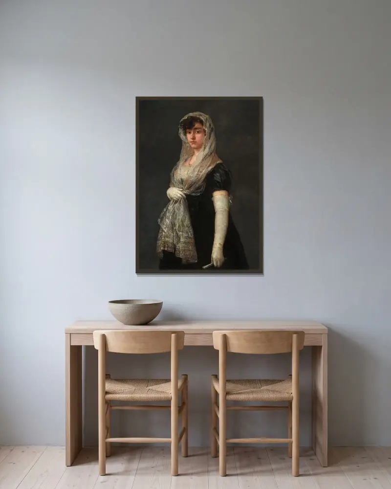 Ung dam med mantilla och basquiña av Francisco de Goya inramad på en vägg