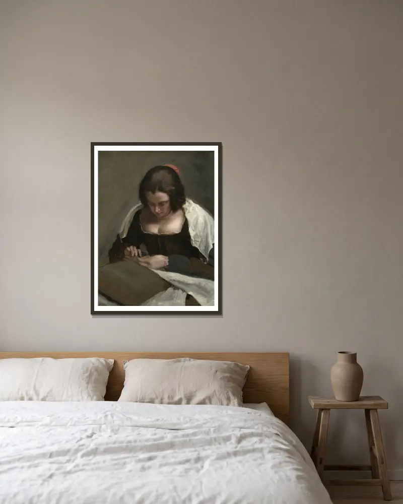 The Needlewoman av Diego Velázquez inramad på en vägg