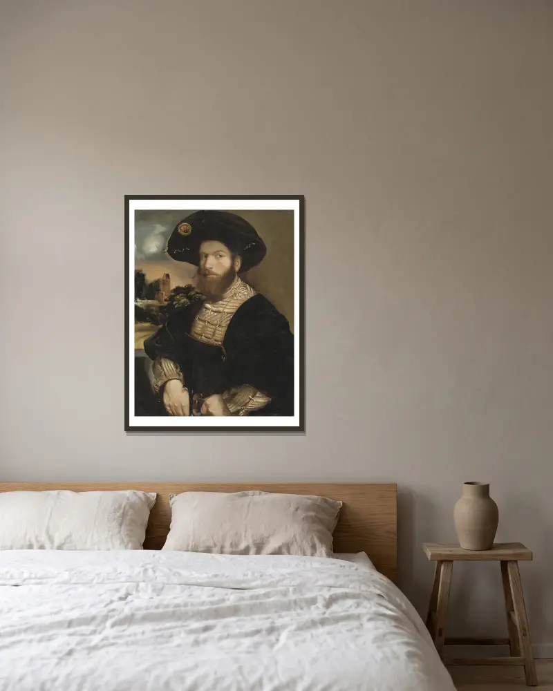 Bildnis eines Mannes mit schwarzem Barett von Dosso Dossi gerahmt an einer Wand