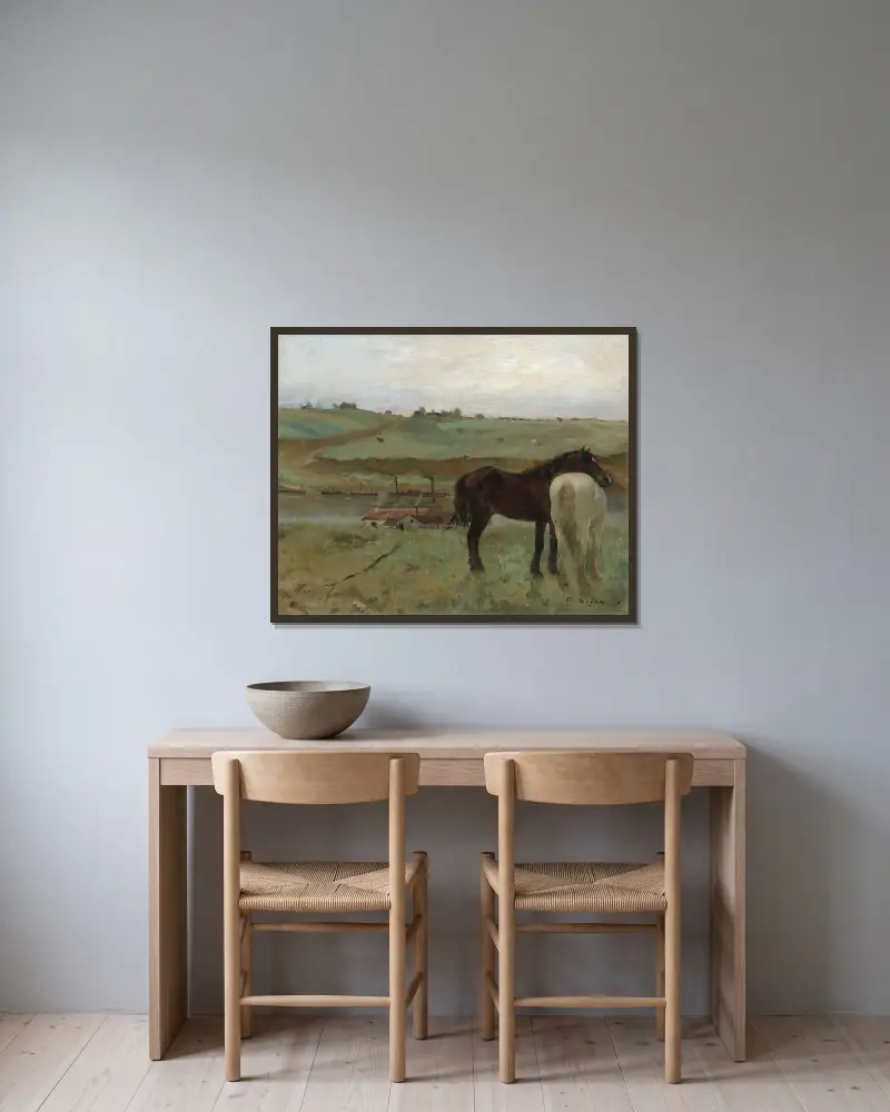 Horses in a Meadow av Edgar Degas inramad på en vägg