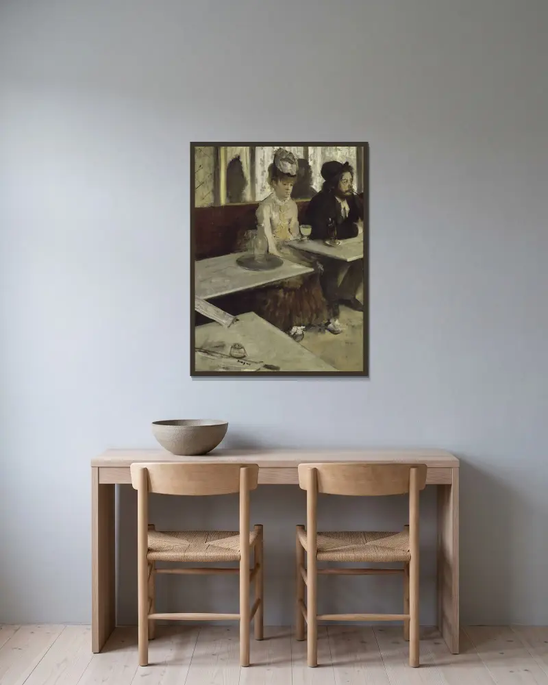 In A Café av Edgar Degas inramad på en vägg