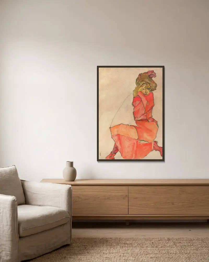 Kneeling Female in Orange-Red Dress av Egon Schiele inramad på en vägg