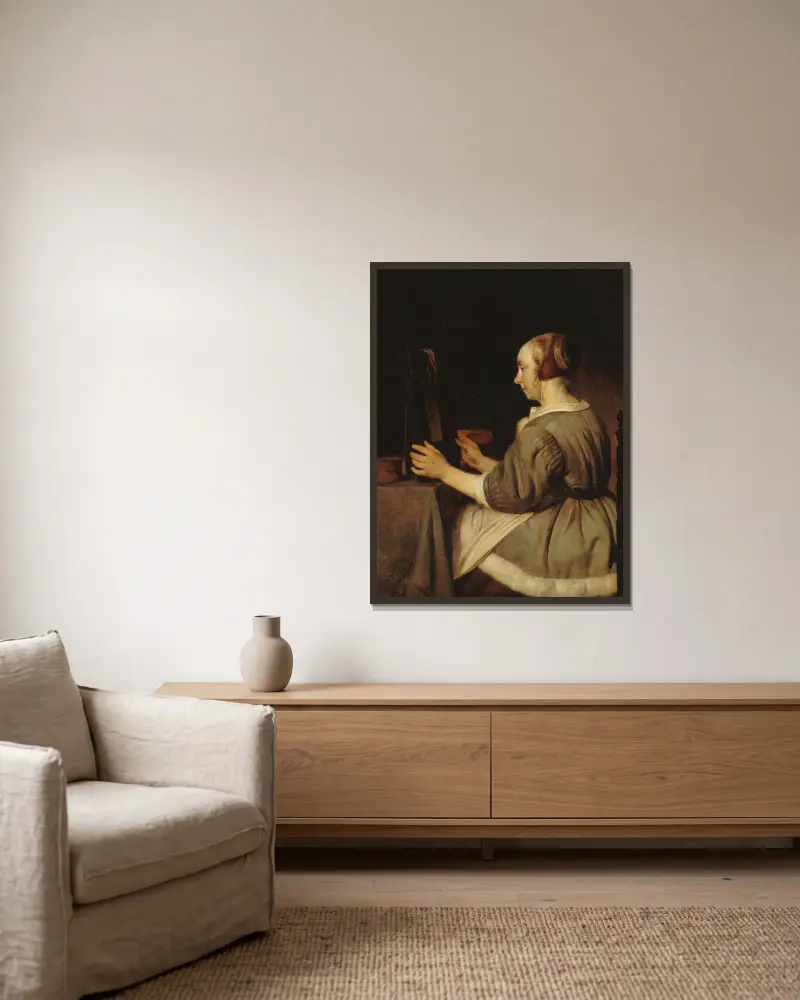 Kvinna med spegel av Gabriel Metsu inramad på en vägg