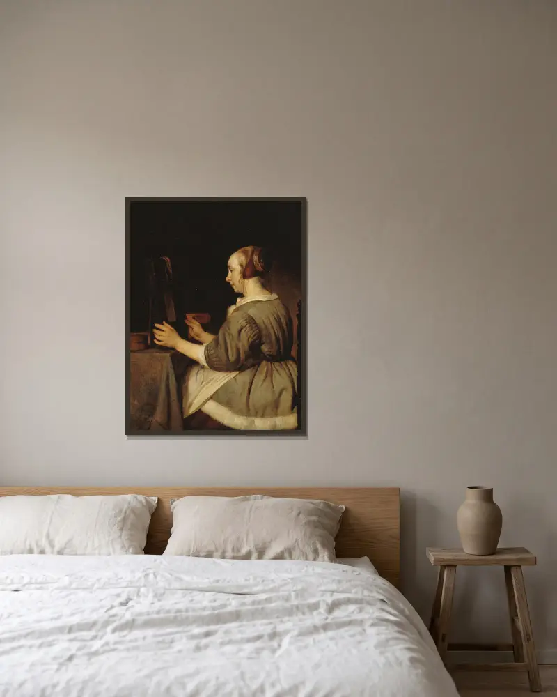 Kvinna med spegel av Gabriel Metsu inramad på en vägg