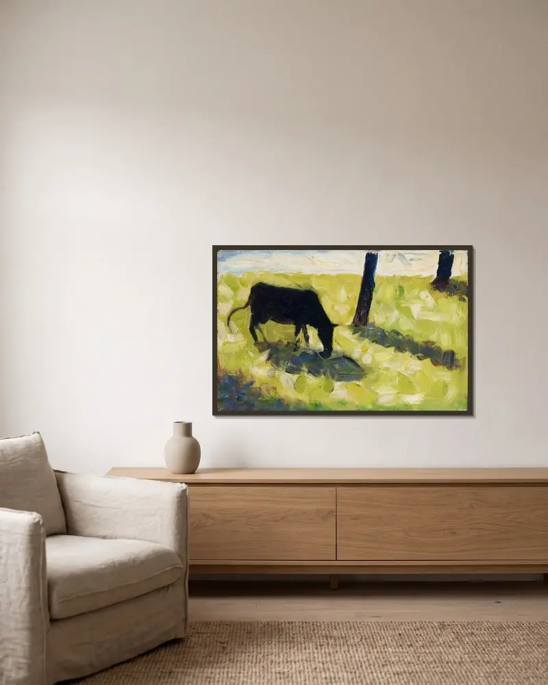 Svart ko på en äng av Georges Seurat inramad på en vägg