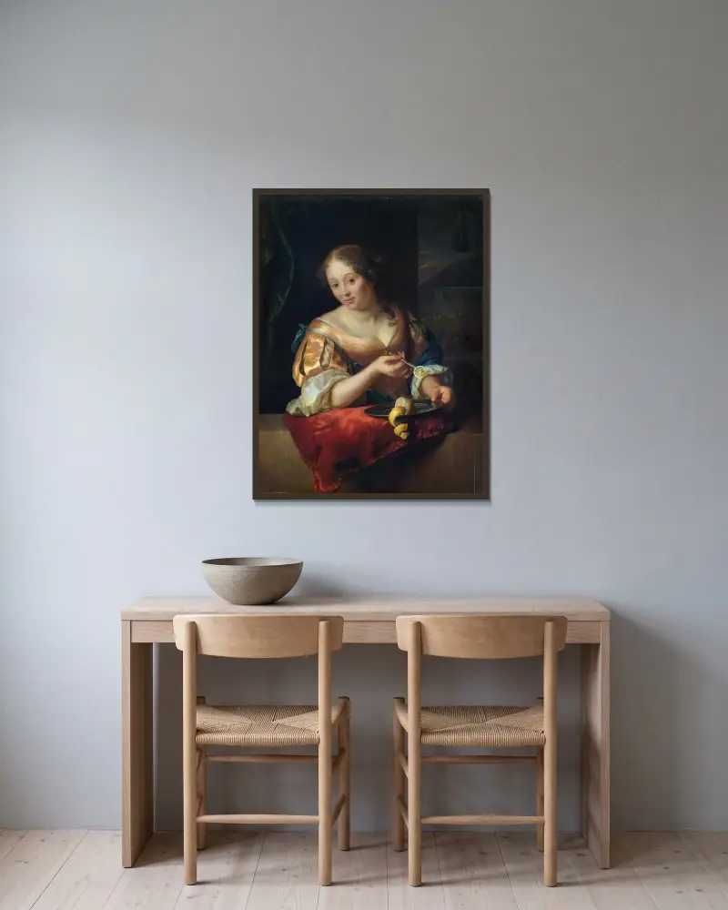 Junge Frau mit Zitrone von Godfried Schalcken gerahmt an einer Wand