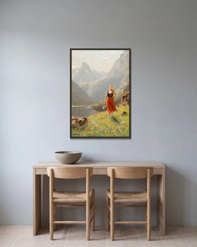 Ung flicka med korg i bergen av Hans Dahl inramad på en vägg