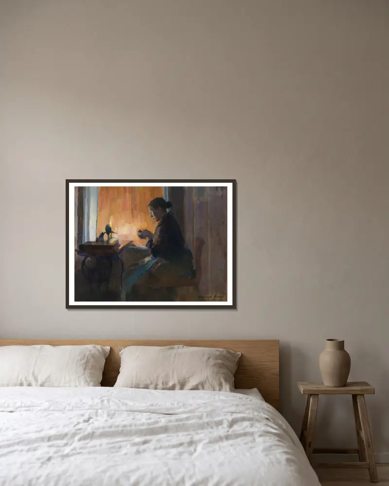 By Lamp Light av Harriet Backer inramad på en vägg
