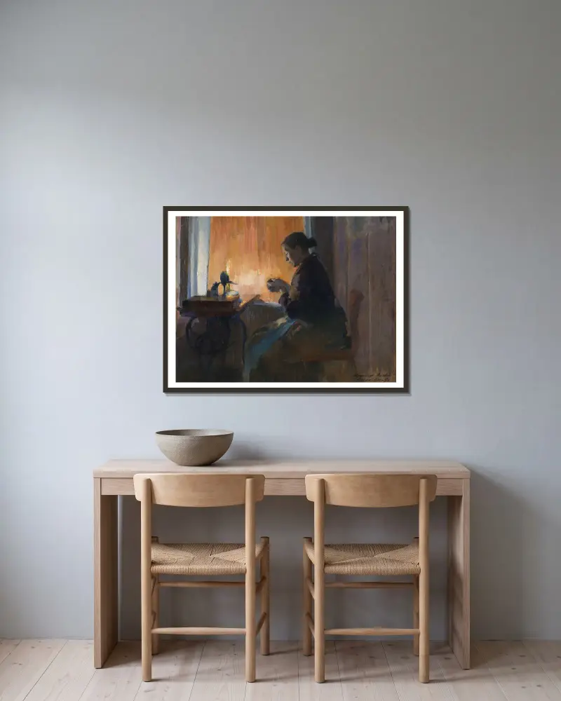 By Lamp Light av Harriet Backer inramad på en vägg