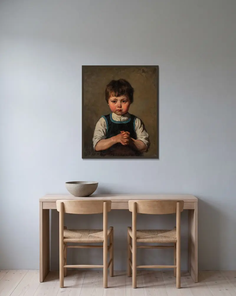 Bildnis eines Jungen von Jenny Nyström gerahmt an einer Wand