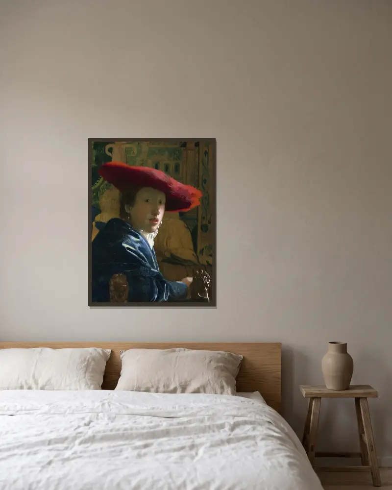 Mädchen mit dem roten Hut von Johannes Vermeer gerahmt an einer Wand