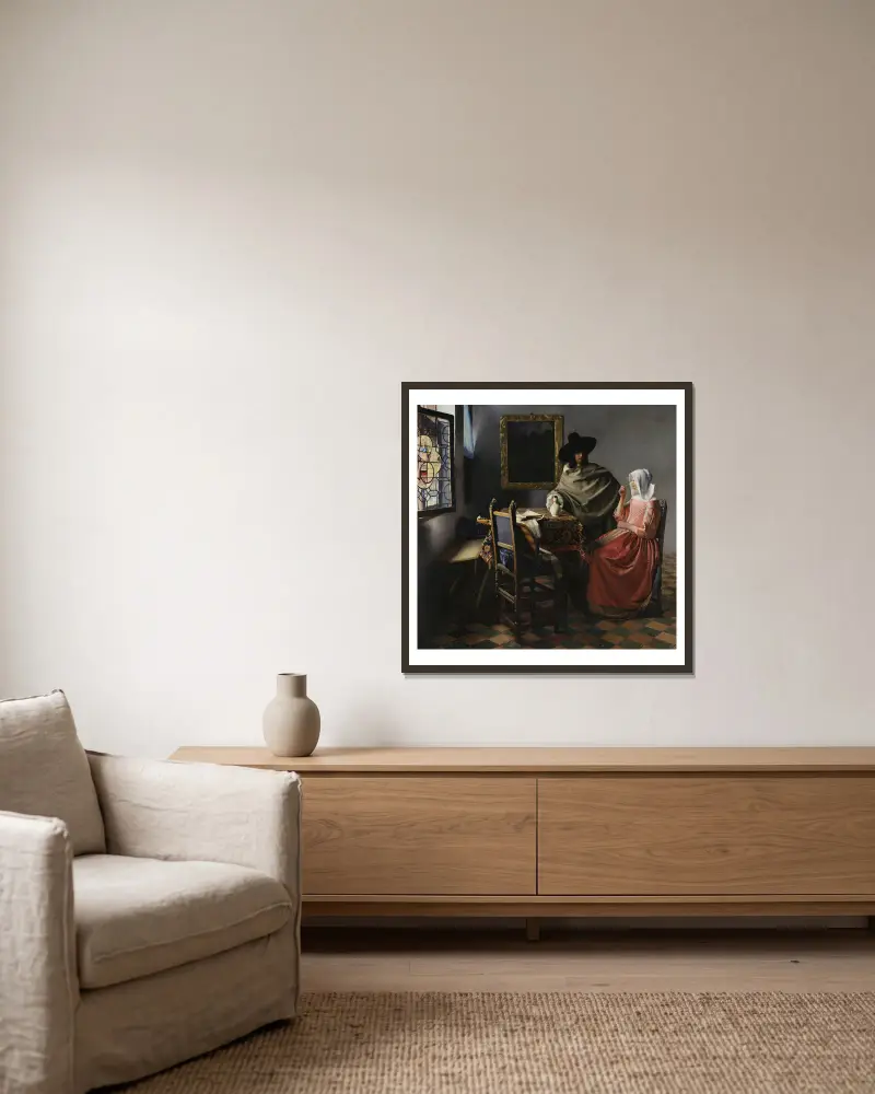The Wine Glass av Johannes Vermeer inramad på en vägg