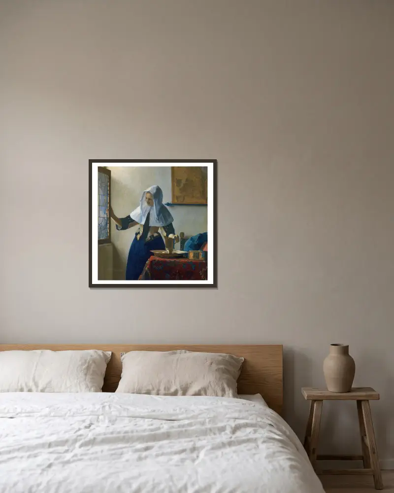 Young Woman with a Water Pitcher av Johannes Vermeer inramad på en vägg