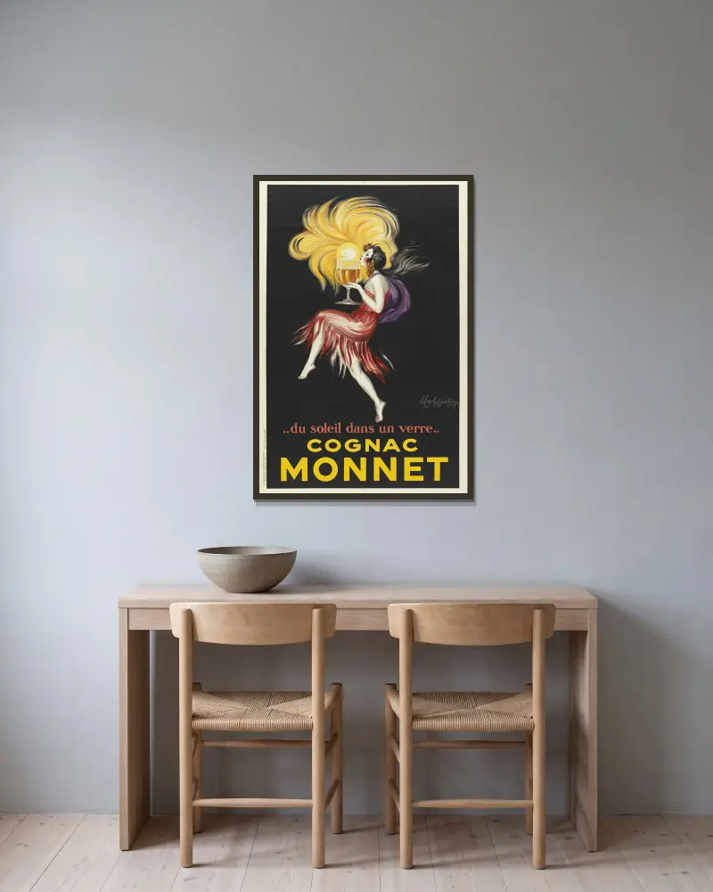 Sol i ett glas. Cognac Monnet av Leonetto Cappiello inramad på en vägg