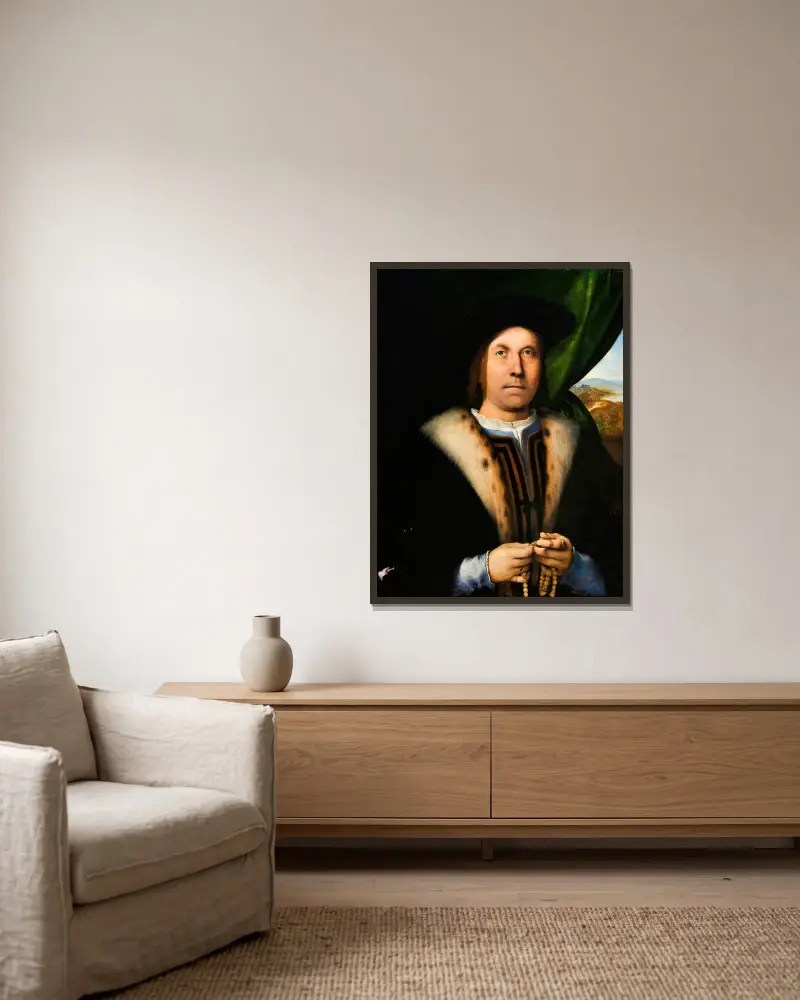 Porträtt av en man med radband av Lorenzo Lotto inramad på en vägg