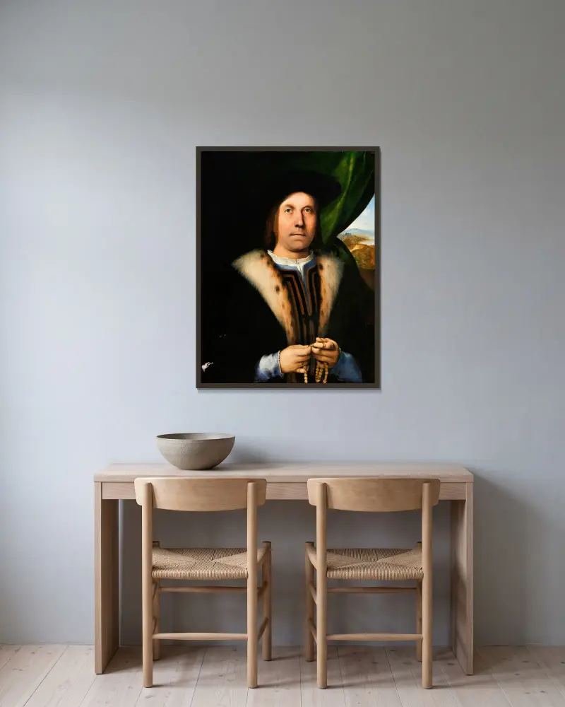 Porträtt av en man med radband av Lorenzo Lotto inramad på en vägg