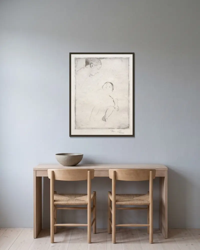 Bill i sin mors knä av Mary Cassatt inramad på en vägg