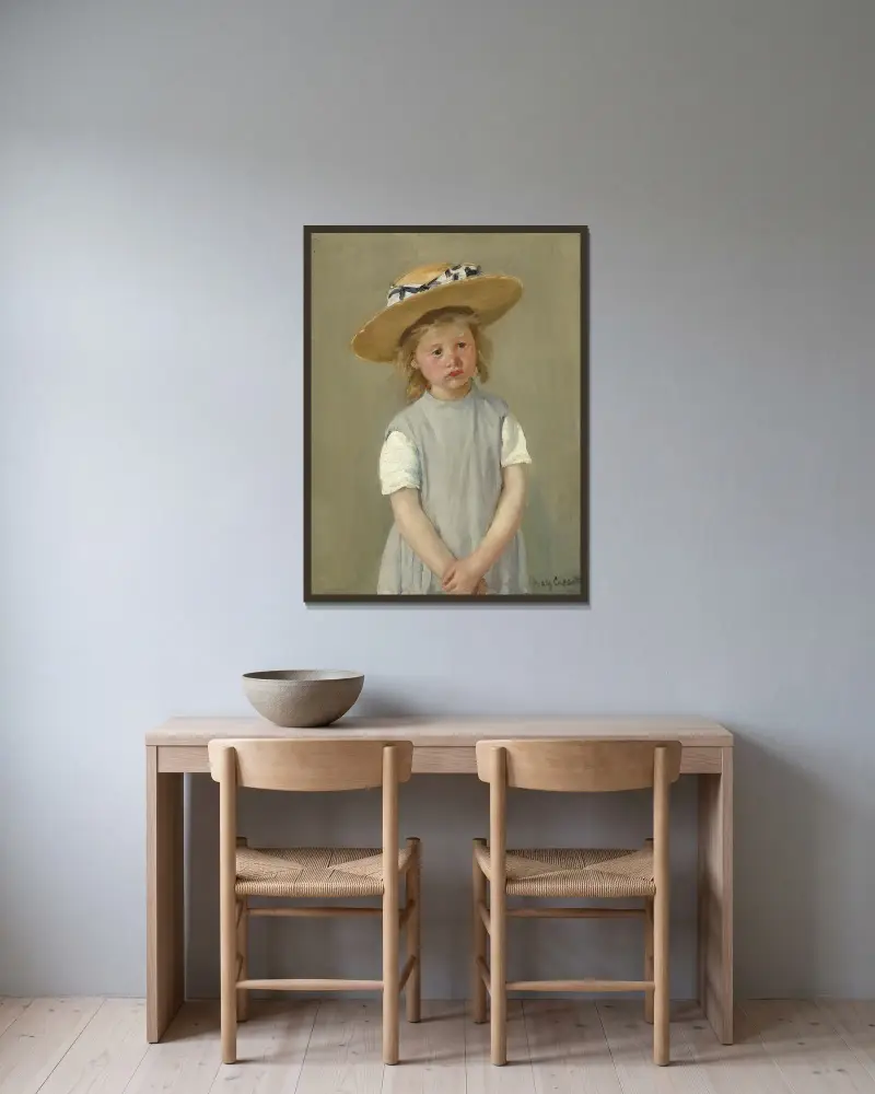 Kind mit Strohhut von Mary Cassatt gerahmt an einer Wand