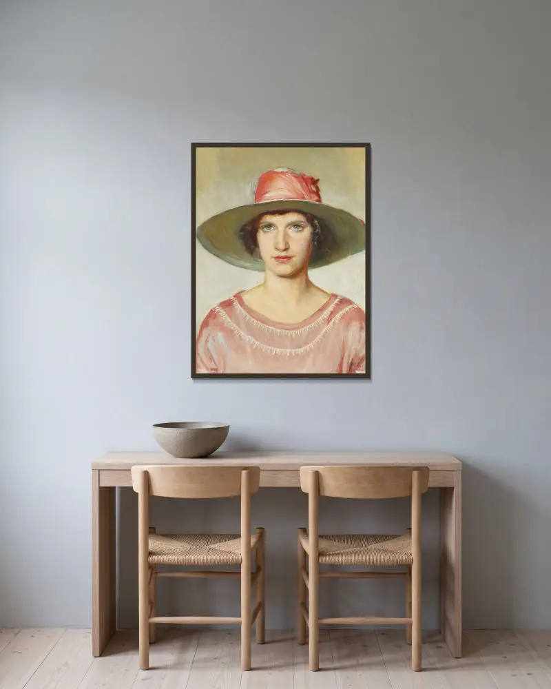 Porträt eines Mädchens in rosa Kleid und Strohhut mit rosa Band von Michael Ancher gerahmt an einer Wand