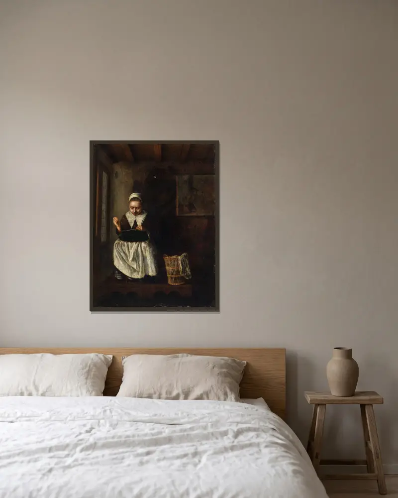 En flicka som syr av Nicolaes Maes inramad på en vägg