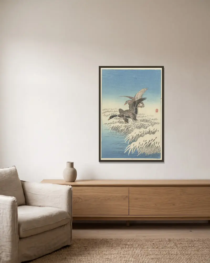Flock av änder som flyger över snötäckt vass av Ohara Koson inramad på en vägg