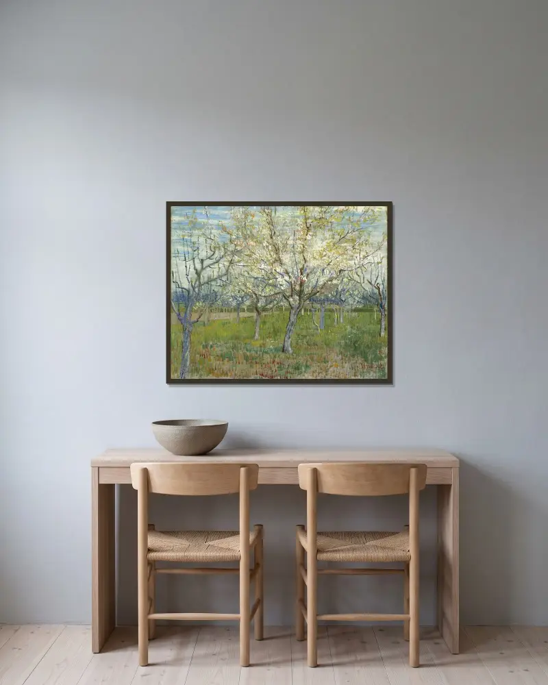 The Pink Orchard av Vincent van Gogh inramad på en vägg